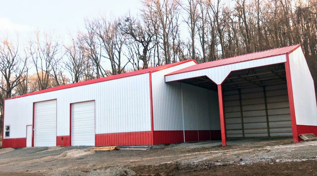 Photo of front of white and red pole barn