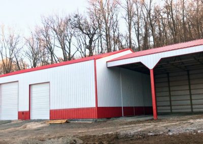 Photo of front of white and red pole barn